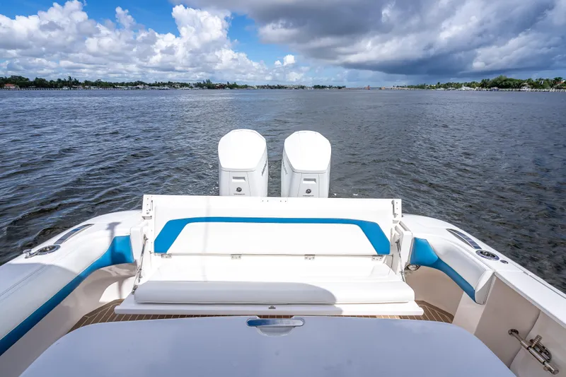  Yacht Photos Pics 2018 Intrepid 407 boat with dual engines on a calm waterway under cloudy skies.