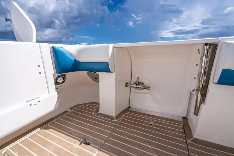  Yacht Photos Pics 2018 Intrepid 407 boat interior with blue and white seating, wooden flooring, and open sky view.