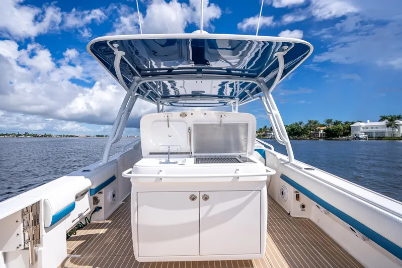  Yacht Photos Pics 2018 Intrepid 407 boat with sleek design, spacious deck, and modern amenities on a sunny day.