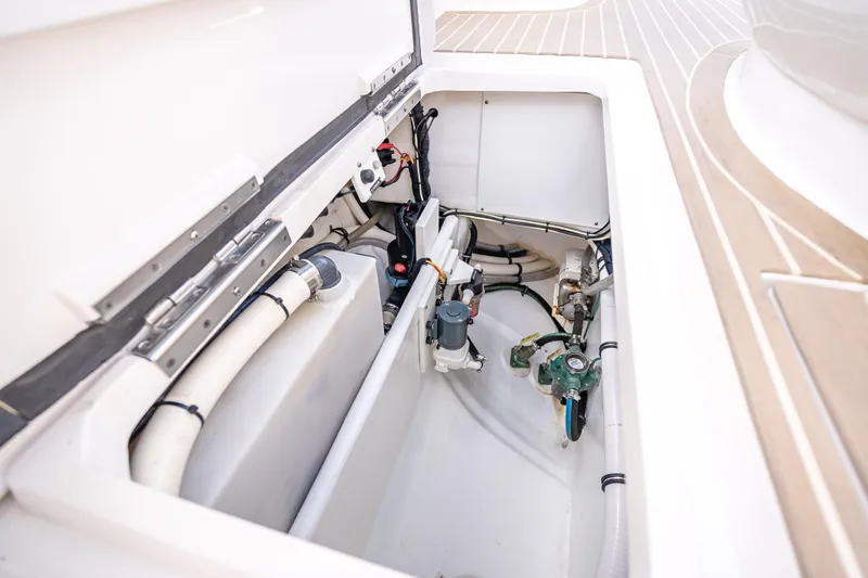  Yacht Photos Pics Engine compartment of a 2018 Intrepid 407 boat, showcasing mechanical components and piping.