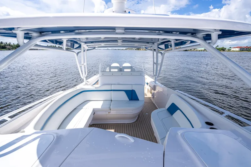  Yacht Photos Pics 2018 Intrepid 407 boat interior with spacious seating on a calm water backdrop.