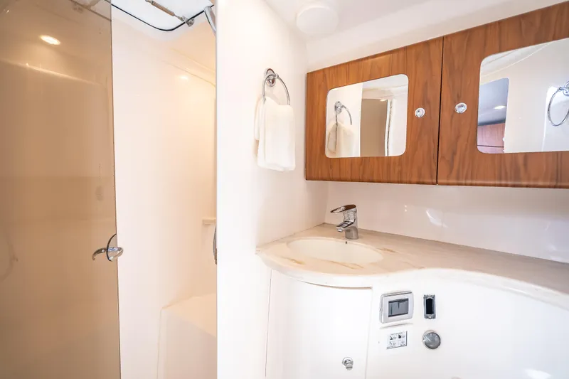  Yacht Photos Pics Luxurious bathroom in 2018 Intrepid 407 yacht with modern fixtures and wooden cabinetry.