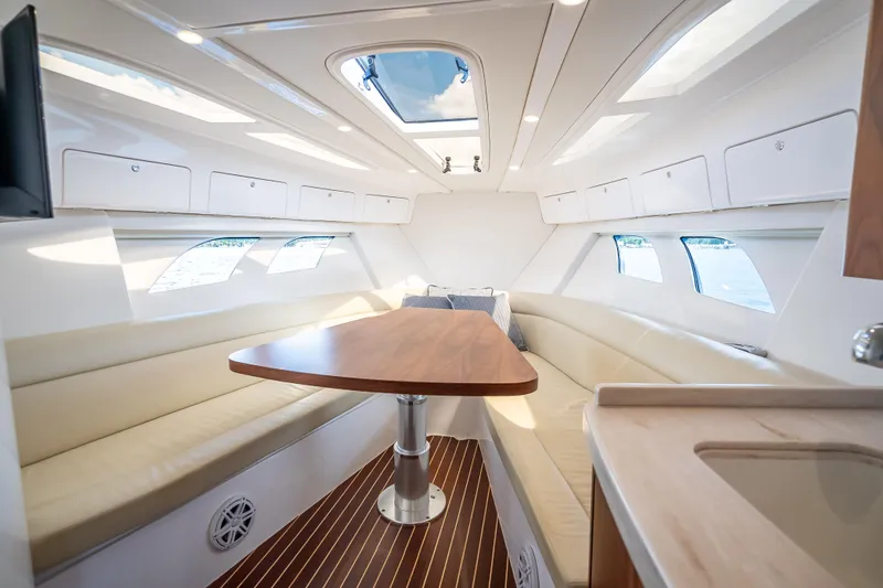 Yacht Photos Pics Luxurious interior of 2018 Intrepid 407 yacht with elegant seating and wooden table.