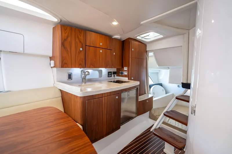  Yacht Photos Pics Luxurious 2018 Intrepid 407 yacht interior with modern kitchen and wooden cabinetry.