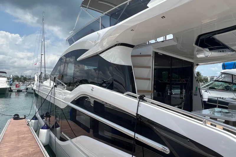  Yacht Photos Pics 2024 Galeon 440 Fly yacht docked at marina under cloudy sky.