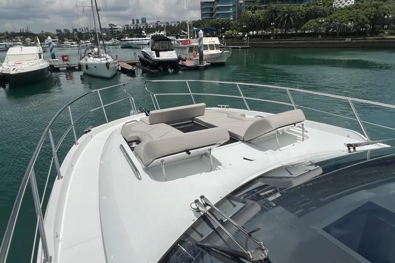  Yacht Photos Pics 2024 Galeon 440 Fly yacht with sun loungers docked in a marina.