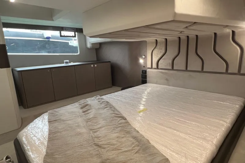  Yacht Photos Pics Luxurious bedroom interior of 2024 Galeon 440 Fly yacht, featuring modern design and ample storage.