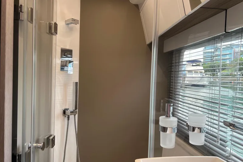  Yacht Photos Pics Modern bathroom interior of 2024 Galeon 440 Fly yacht with sleek fixtures and window view.