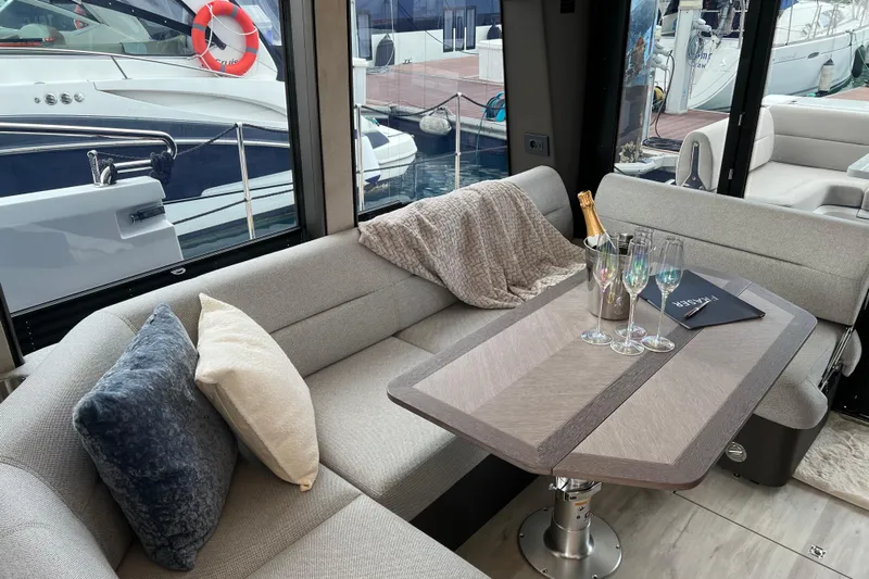  Yacht Photos Pics Luxurious interior of 2024 Galeon 440 Fly yacht with elegant seating and table setting.