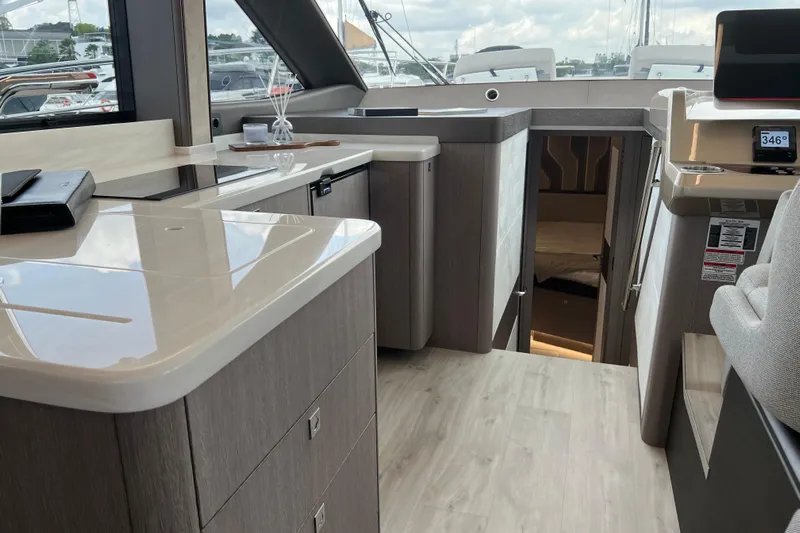  Yacht Photos Pics Interior of 2024 Galeon 440 Fly yacht, featuring modern kitchen and cozy cabin entrance.
