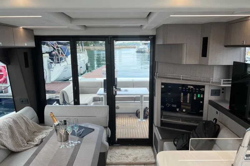  Yacht Photos Pics Interior of 2024 Galeon 440 Fly yacht with elegant seating and marina view.
