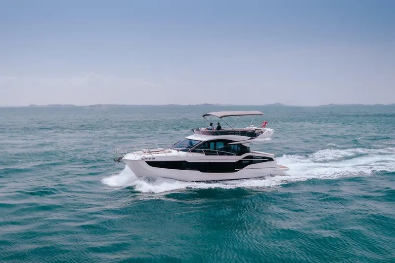  Yacht Photos Pics 2024 Galeon 440 Fly yacht cruising on open sea under clear blue sky.