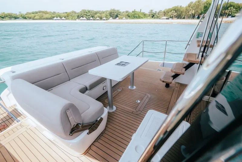  Yacht Photos Pics 2024 Galeon 440 Fly yacht deck with seating and table, overlooking serene waters.