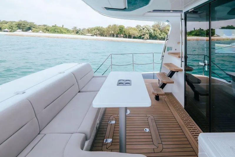  Yacht Photos Pics 2024 Galeon 440 Fly yacht deck with seating, table, and ocean view.