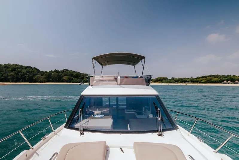  Yacht Photos Pics 2024 Galeon 440 Fly yacht cruising near a scenic coastline.