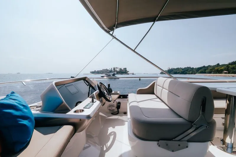  Yacht Photos Pics 2024 Galeon 440 Fly yacht interior with ocean view, featuring luxurious seating and helm.