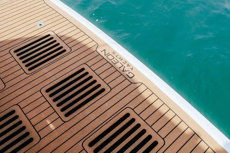  Yacht Photos Pics Teak deck of 2024 Galeon 440 Fly yacht beside turquoise water.