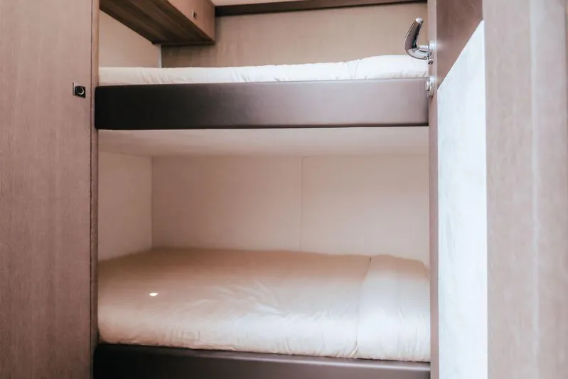  Yacht Photos Pics Bunk beds in 2024 Galeon 440 Fly yacht cabin, featuring modern design and cozy bedding.