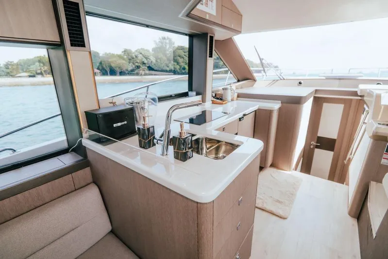  Yacht Photos Pics Luxurious interior of 2024 Galeon 440 Fly yacht with modern kitchen and scenic window view.