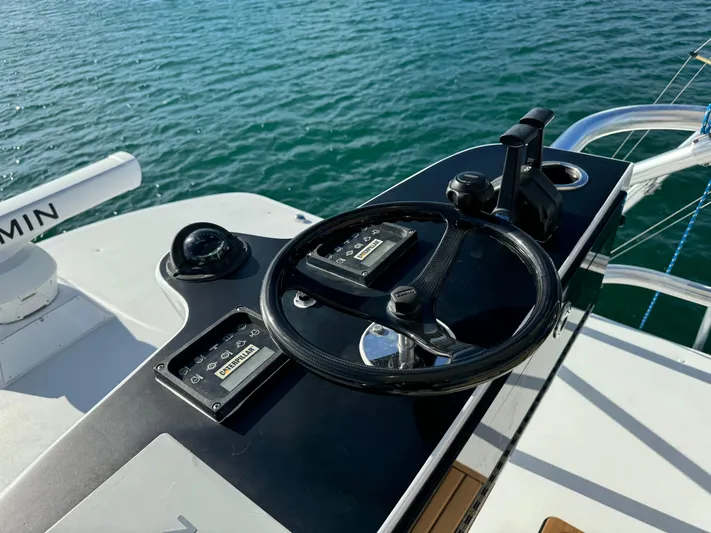 Hook Up Yacht Photos Pics Steering console of a 2004 Predator 35 boat on calm water.