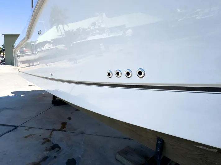 Pearl Yacht Photos Pics 2018 Boston Whaler 315 Conquest boat hull with reflective surface and dock setting.