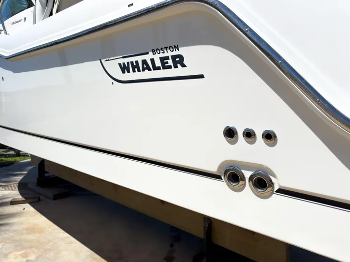 Pearl Yacht Photos Pics 2018 Boston Whaler 315 Conquest boat side view with logo and chrome fittings.
