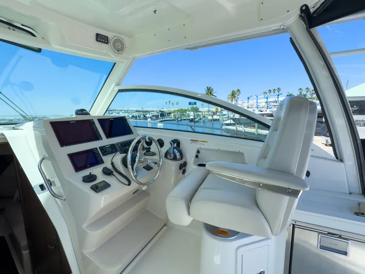 Pearl Yacht Photos Pics 2018 Boston Whaler 315 Conquest helm with modern controls and marina view.
