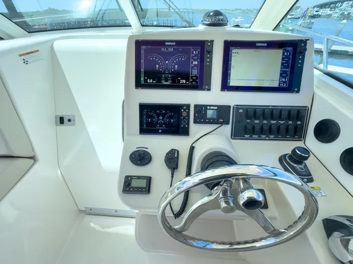 Pearl Yacht Photos Pics Control panel of a 2018 Boston Whaler 315 Conquest boat with navigation screens.