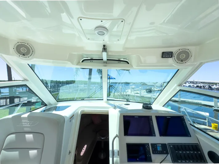 Pearl Yacht Photos Pics Interior view of 2018 Boston Whaler 315 Conquest boat cockpit with navigation screens.
