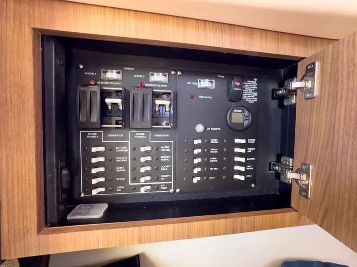 Pearl Yacht Photos Pics Electrical panel inside a 2018 Boston Whaler 315 Conquest boat, featuring switches and circuit breakers.