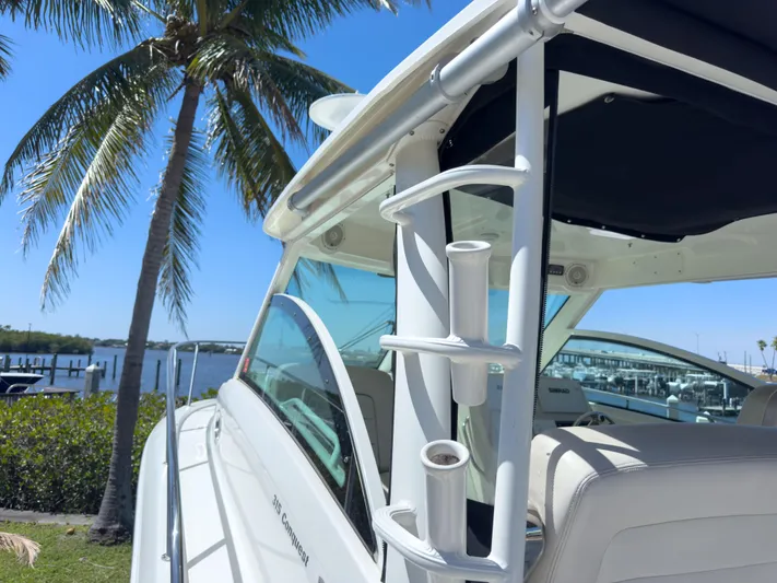 Pearl Yacht Photos Pics 2018 Boston Whaler 315 Conquest boat docked near palm trees and water.