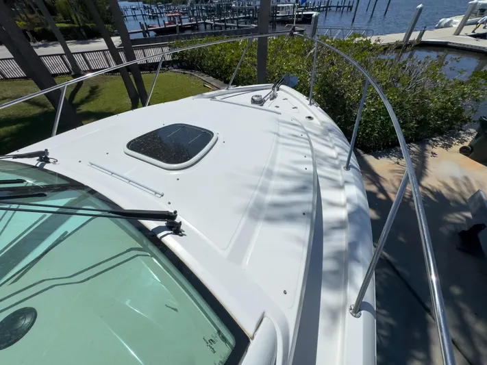 Pearl Yacht Photos Pics 2018 Boston Whaler 315 Conquest boat deck with railing, docked near waterfront.
