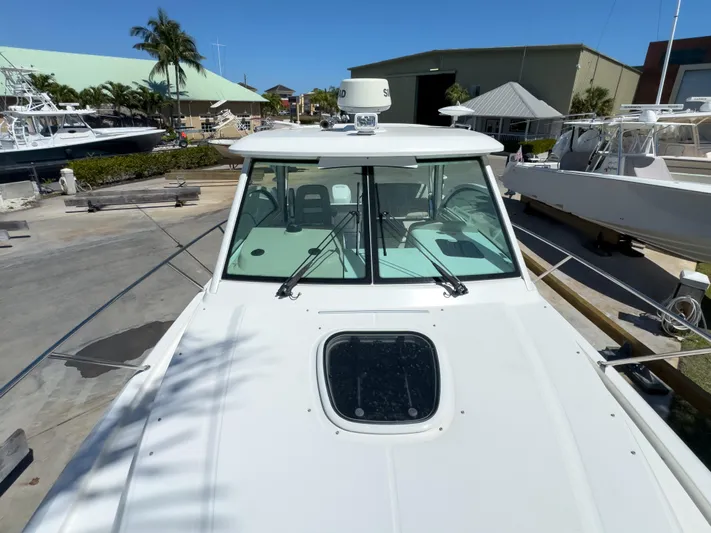 Pearl Yacht Photos Pics 2018 Boston Whaler 315 Conquest boat docked, showcasing front deck and windshield.