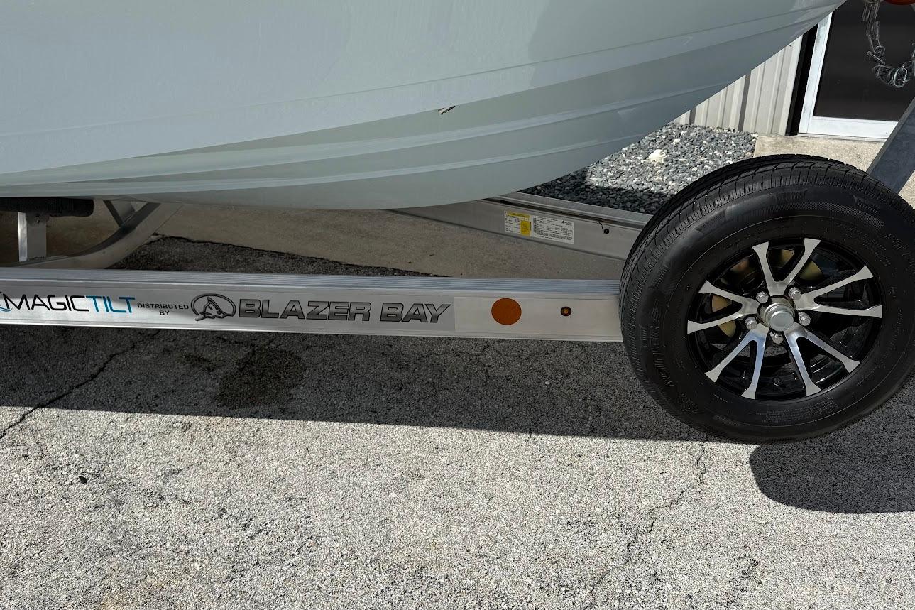 2026 Blazer PureBay 2400 boat trailer with Magic Tilt branding, parked on concrete.