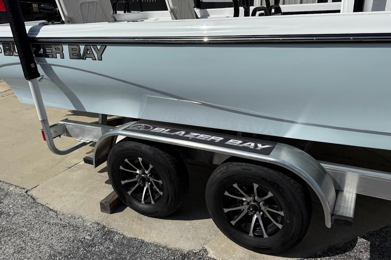 2026 Blazer PureBay 2400 boat on trailer with stylish wheels.
