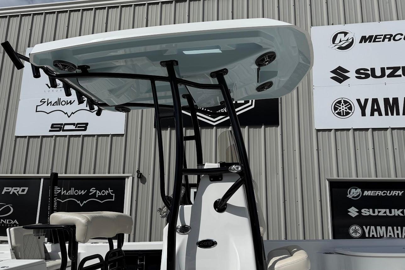 2026 Blazer PureBay 2400 boat with T-top, displayed at a marine dealership.