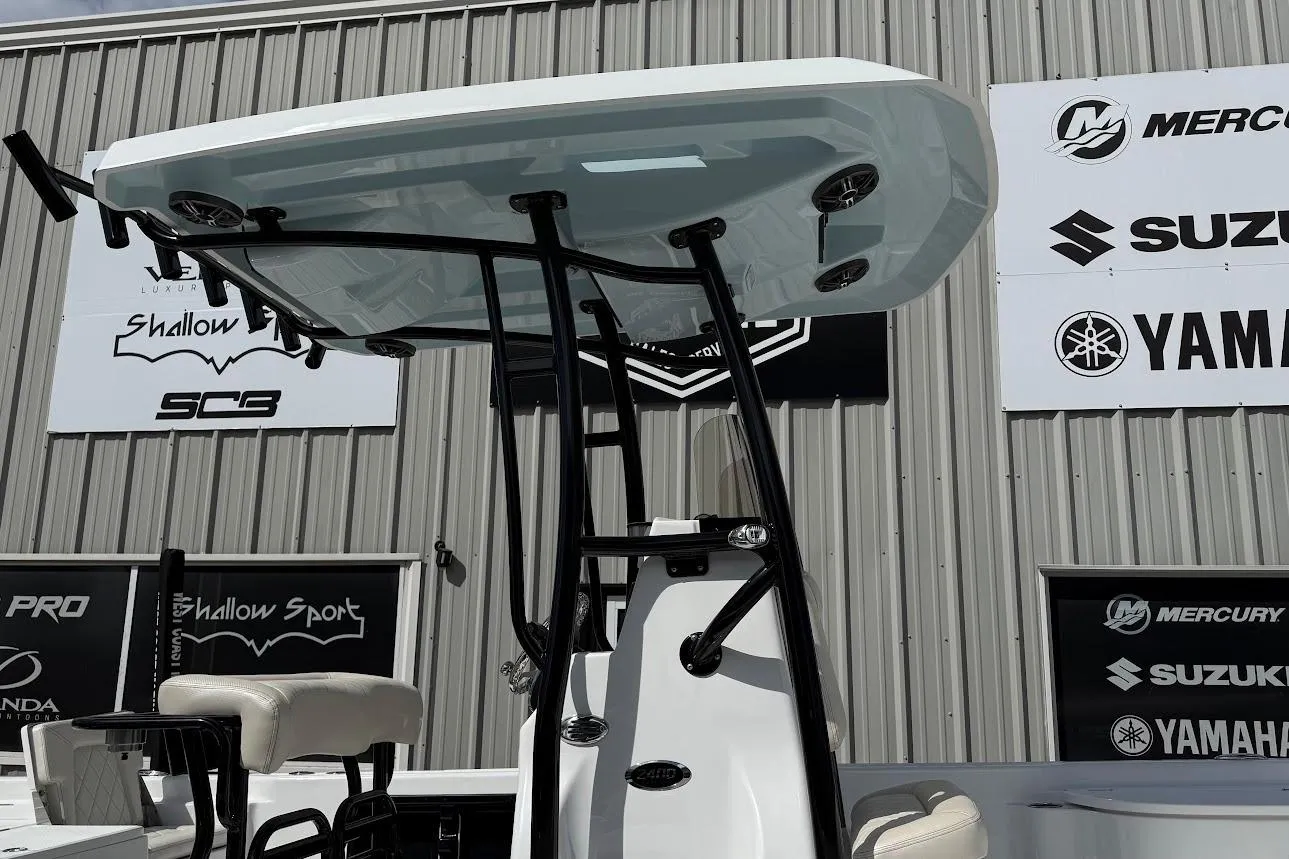 2026 Blazer PureBay 2400 boat with T-top, displayed at a marine dealership.