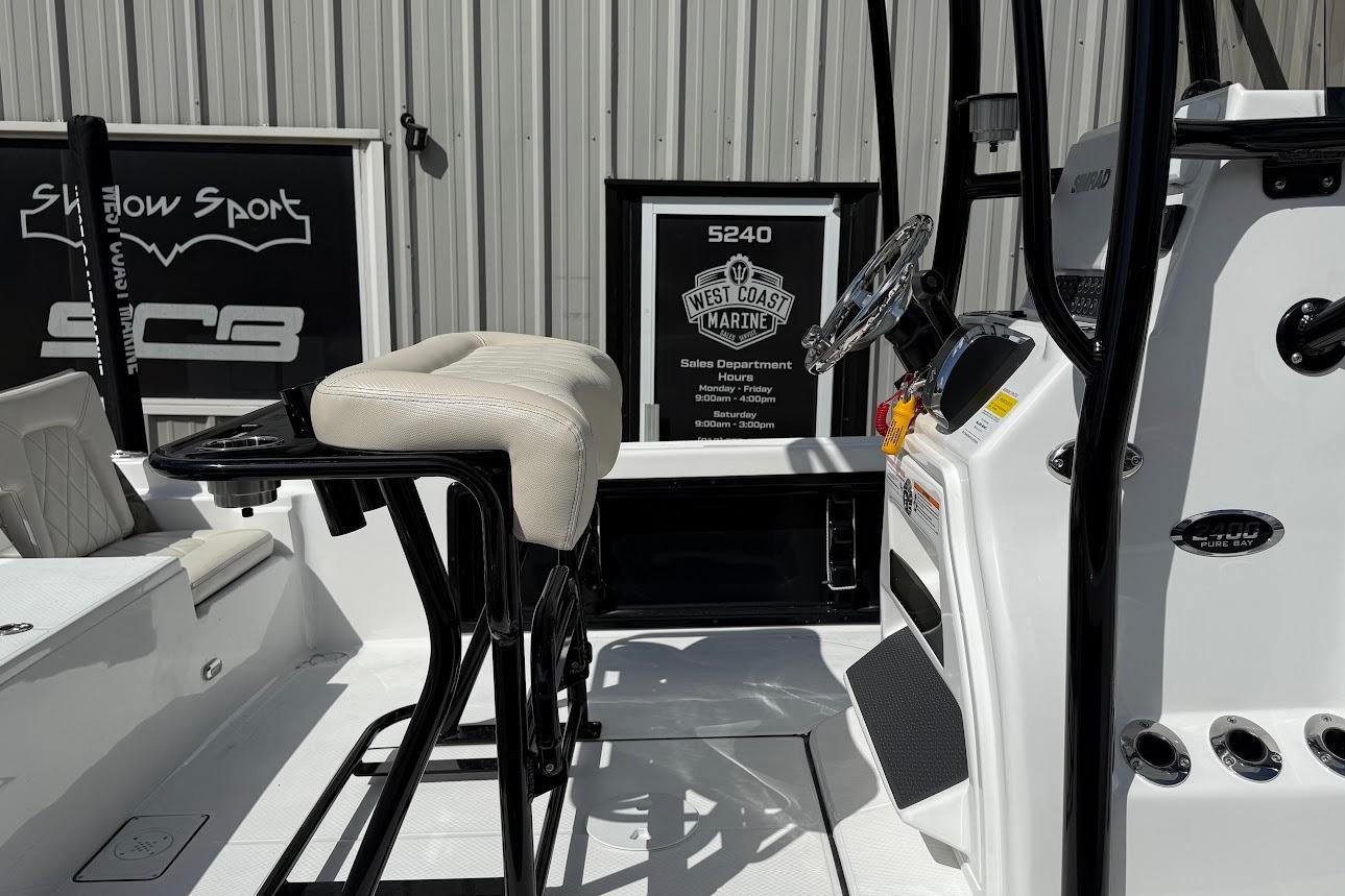 2026 Blazer PureBay 2400 boat interior with steering console and seating.