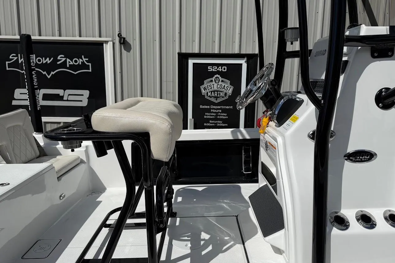 2026 Blazer PureBay 2400 boat interior with steering console and seating.