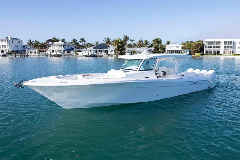  Yacht Photos Pics Manufacturer Provided Image: 2026 HCB 48 Campeon boat on clear water near luxury waterfront homes.