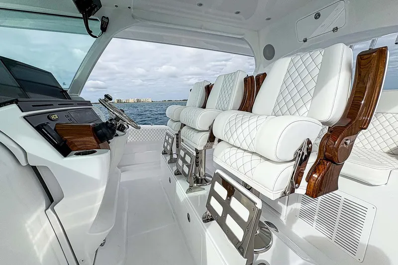  Yacht Photos Pics Manufacturer Provided Image: Luxurious interior of 2026 HCB 48 Campeon boat with plush white seating and modern controls.