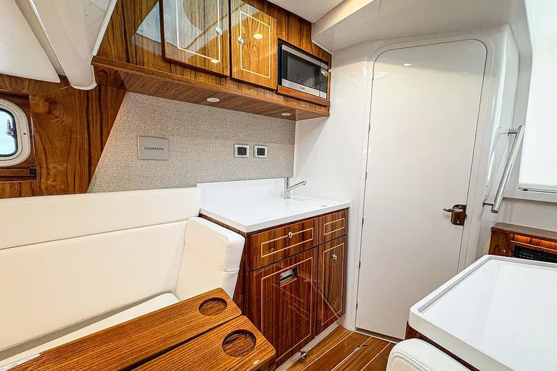  Yacht Photos Pics Manufacturer Provided Image: Interior of 2026 HCB 48 Campeon yacht with wood cabinetry and modern amenities.