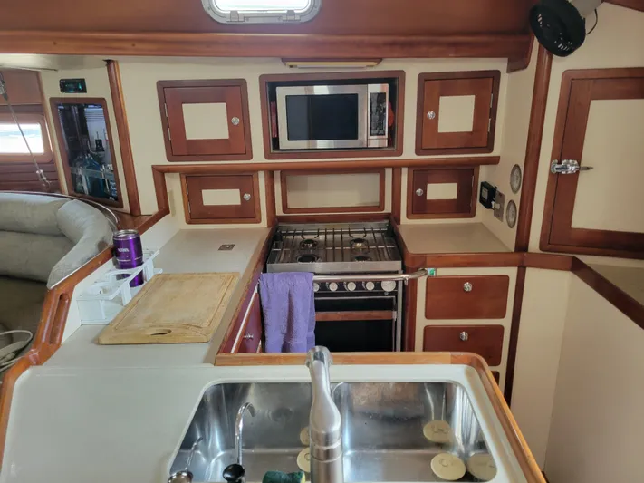 3/4 Time Yacht Photos Pics Interior of 1996 Little Harbor 51 Pilothouse yacht kitchen with stove, sink, and microwave.