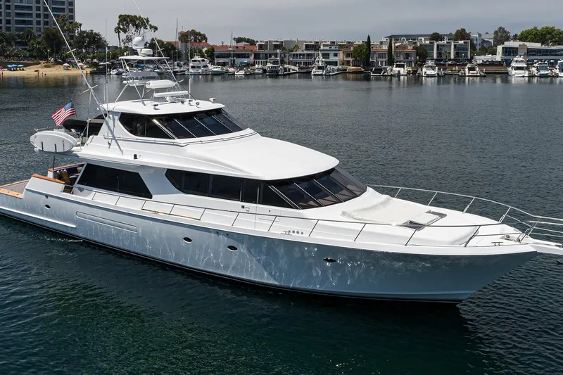 Fan Tail Yacht Photos Pics 2003 West Bay Sonship yacht cruising in a marina, showcasing sleek design and luxury features.