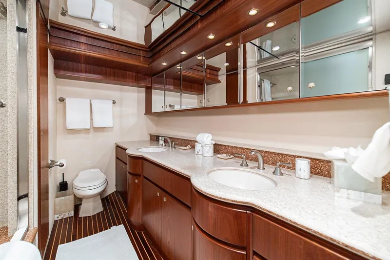 Fan Tail Yacht Photos Pics Luxurious 2003 West Bay Sonship yacht bathroom with elegant wood cabinetry and dual sinks.