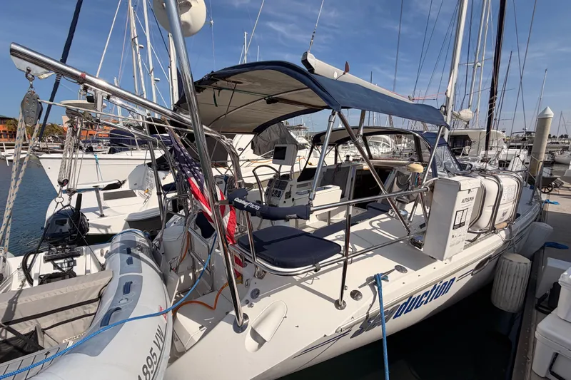 Seaduction Yacht Photos Pics 2005 Catalina 42 MkII sailboat docked at marina, featuring blue canopy and American flag.