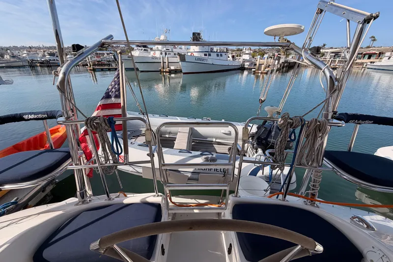 Seaduction Yacht Photos Pics 2005 Catalina 42 MkII sailboat docked in marina, featuring American flag and nautical equipment.
