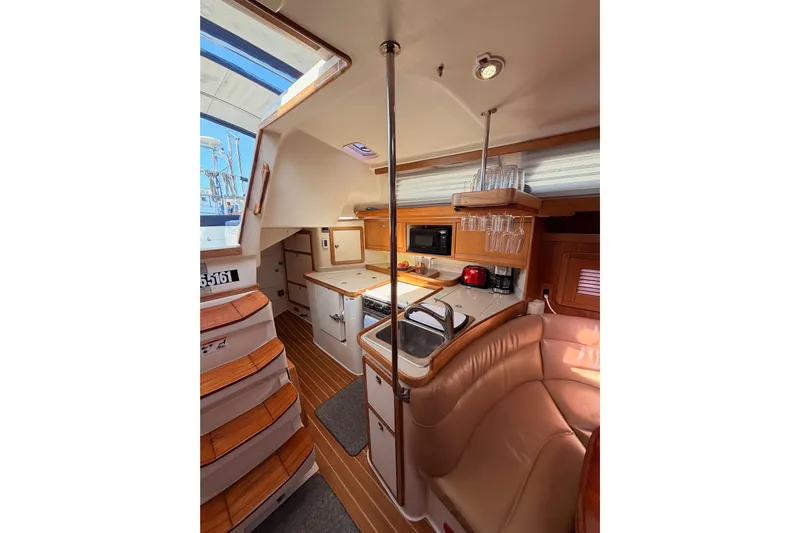 Seaduction Yacht Photos Pics Interior of 2005 Catalina 42 MkII sailboat with kitchen and seating area.