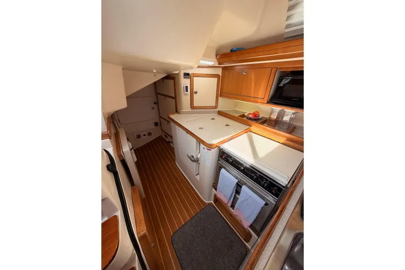 Seaduction Yacht Photos Pics Interior of 2005 Catalina 42 MkII sailboat, featuring a compact, well-equipped kitchen area.