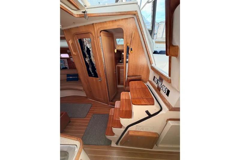 Seaduction Yacht Photos Pics Interior of 2005 Catalina 42 MkII sailboat with wooden steps and cabin view.